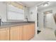 Bright kitchen with light wood cabinets, granite countertops, and stainless steel appliances at 8701 Midnight Pass Rd # 106A, Sarasota, FL 34242