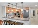 Modern kitchen with light wood cabinets and breakfast bar at 8701 Midnight Pass Rd # 106A, Sarasota, FL 34242