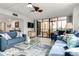 Relaxing living room with blue sofas, a coffee table, and access to a balcony at 8701 Midnight Pass Rd # 106A, Sarasota, FL 34242