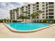 Resort-style pool with hot tub, lounge chairs, and patio tables at 8701 Midnight Pass Rd # 106A, Sarasota, FL 34242