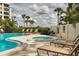Relaxing hot tub and lounge chairs near the refreshing pool at 8701 Midnight Pass Rd # 106A, Sarasota, FL 34242