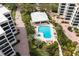 Relaxing kidney-shaped pool with patio and tropical landscaping at 8701 Midnight Pass Rd # 106A, Sarasota, FL 34242