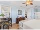 Bright bedroom with light blue walls and wood floors, with an interior view to the adjacent living room at 12147 Maple Ridge Dr, Parrish, FL 34219