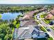 Houses with tile roofs and pools situated along a canal and residential street at 19864 Petrino St, Venice, FL 34293