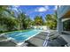 Relaxing pool area with lounge chairs and a refreshing pool at 212 Spring Ave, Anna Maria, FL 34216