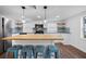Modern kitchen with large island, white cabinets, and blue tile backsplash at 3919 116Th Street W Ct, Bradenton, FL 34210
