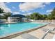 Inviting community pool with lounge chairs and covered seating area at 6854 Wagon Wheel Cir, Sarasota, FL 34243