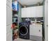 Laundry room with washer, dryer, and storage shelves at 6854 Wagon Wheel Cir, Sarasota, FL 34243