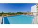 Community pool with plenty of lounge chairs and a pergola at 101 S Gulfstream Ave # 11E, Sarasota, FL 34236