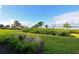 Landscaped backyard with view of the water and lush vegetation at 1010 Tidewater Shores Loop # 103, Bradenton, FL 34208