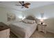 Spacious bedroom with a king-size bed and ceiling fan at 1010 Tidewater Shores Loop # 103, Bradenton, FL 34208