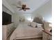 King-size bed and dresser in bright bedroom with ceiling fan at 1010 Tidewater Shores Loop # 103, Bradenton, FL 34208