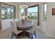 Elegant dining room with round table, chairs, and large windows at 1010 Tidewater Shores Loop # 103, Bradenton, FL 34208