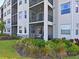 Exterior view of the condo building with balconies and landscaping at 1010 Tidewater Shores Loop # 103, Bradenton, FL 34208