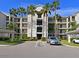 Front view of the condo building with parking and landscaping at 1010 Tidewater Shores Loop # 103, Bradenton, FL 34208