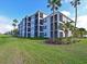 Exterior view of the condo building with balconies and landscaping at 1010 Tidewater Shores Loop # 103, Bradenton, FL 34208