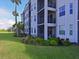 Exterior view of the condo building with balconies and landscaping at 1010 Tidewater Shores Loop # 103, Bradenton, FL 34208