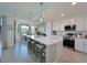 Spacious kitchen with island, stainless steel appliances, and white cabinets at 1010 Tidewater Shores Loop # 103, Bradenton, FL 34208