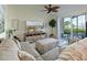 Relaxing living room with sectional sofa and access to patio at 1010 Tidewater Shores Loop # 103, Bradenton, FL 34208
