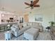 Open living room with sectional sofa and views of kitchen at 1010 Tidewater Shores Loop # 103, Bradenton, FL 34208