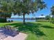 Park bench overlooking a calm lake at 1010 Tidewater Shores Loop # 103, Bradenton, FL 34208