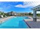 Community pool with lounge chairs and cabanas at 1010 Tidewater Shores Loop # 103, Bradenton, FL 34208