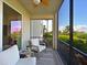 Relaxing screened porch with patio furniture and view of lush landscape at 1010 Tidewater Shores Loop # 103, Bradenton, FL 34208
