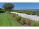 Landscaped waterfront walking path with benches at 1010 Tidewater Shores Loop # 103, Bradenton, FL 34208