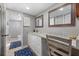 Bathroom with granite countertop, white cabinets, and a walk-in shower at 1325 Siesta Bayside Dr # 1325B, Sarasota, FL 34242