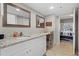 Bathroom boasts granite countertops, white cabinets, and a view into a bedroom at 1325 Siesta Bayside Dr # 1325B, Sarasota, FL 34242