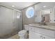 Bathroom with granite vanity, a toilet, and a large walk-in shower at 1325 Siesta Bayside Dr # 1325B, Sarasota, FL 34242