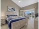 Bedroom with king-size bed, access to a private balcony, and ocean view at 1325 Siesta Bayside Dr # 1325B, Sarasota, FL 34242