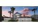 Two-story waterfront home with attached garage and palm trees at 1325 Siesta Bayside Dr # 1325B, Sarasota, FL 34242
