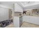Bright kitchen with white cabinets, granite counters, and stainless steel appliances at 1325 Siesta Bayside Dr # 1325B, Sarasota, FL 34242