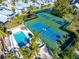 Community tennis courts and pool, surrounded by lush landscaping at 1325 Siesta Bayside Dr # 1325B, Sarasota, FL 34242