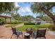 Brick patio with fire pit and comfortable seating, perfect for outdoor gatherings at 1827 Baywood Dr, Sarasota, FL 34231