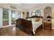 Spacious bedroom with a large, ornate bed and access to a private balcony at 1827 Baywood Dr, Sarasota, FL 34231