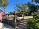 Elevated deck with stairs leading down to the pool area at 1827 Baywood Dr, Sarasota, FL 34231