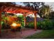 Cozy fire pit area with pergola and comfortable seating for evenings outdoors at 1827 Baywood Dr, Sarasota, FL 34231