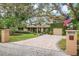 Two-story home with lush landscaping and gated entry at 1827 Baywood Dr, Sarasota, FL 34231