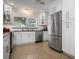 Modern white kitchen with stainless steel appliances and terrazzo flooring at 1827 Baywood Dr, Sarasota, FL 34231