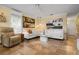 Spacious living room featuring a white sectional sofa and built-in shelving at 1827 Baywood Dr, Sarasota, FL 34231