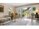 Bright living room with sliding glass doors opening to a patio and lush backyard at 1827 Baywood Dr, Sarasota, FL 34231