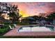 Tranquil pool area at sunset, reflecting the colorful sky at 1827 Baywood Dr, Sarasota, FL 34231