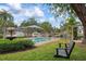 Inviting pool area with a tranquil setting and a relaxing swing bench at 1827 Baywood Dr, Sarasota, FL 34231