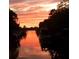 Scenic sunset over calm canal waters with boats at 1827 Baywood Dr, Sarasota, FL 34231