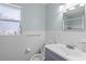 Clean bathroom with white tiled walls, a vanity with sink, and a toilet at 2343 Prospect St, Sarasota, FL 34239