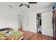 Bedroom with wood floors, a ceiling fan, and a large closet at 2343 Prospect St, Sarasota, FL 34239