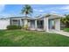 Charming light blue house with carport, well-maintained lawn, and landscaping at 2343 Prospect St, Sarasota, FL 34239