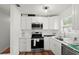 Updated kitchen featuring white cabinets, stainless steel appliances, and white countertops at 2343 Prospect St, Sarasota, FL 34239